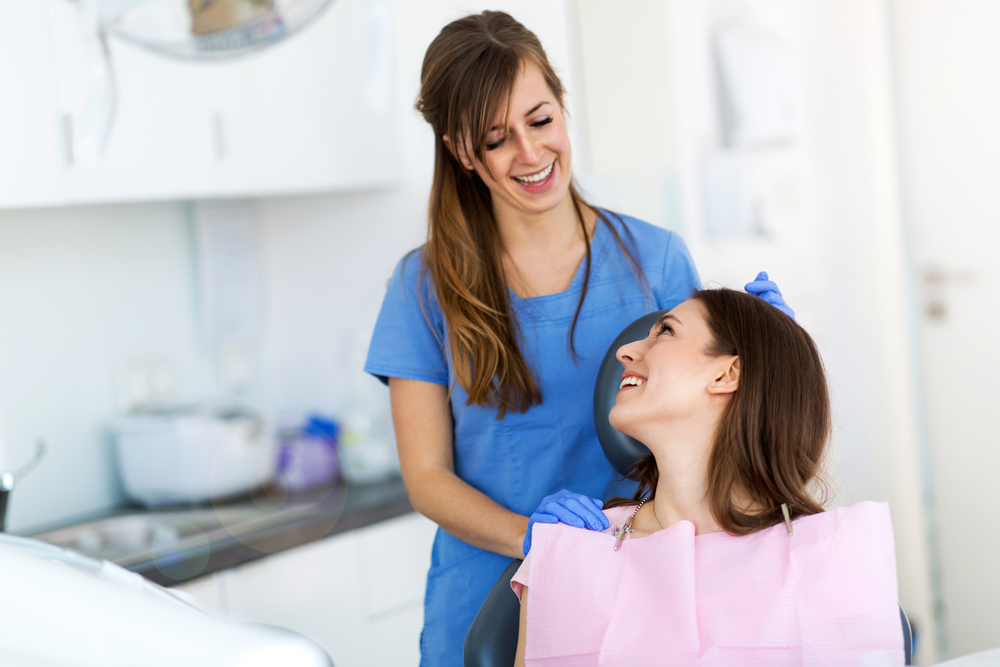 Happy Patient With Dentist at Dental Clinic